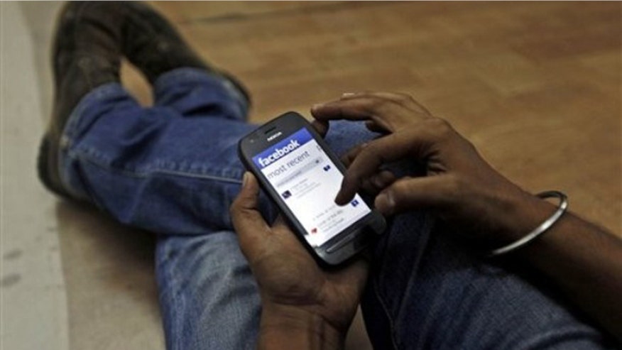 man surfs facebook on phone.jpg